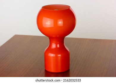 A 60s Modern Orange Bedside Lamp With Glass Spaceage Vintage Midcentury Design Front Side View Isolated On White Background With Warm Orange Light In The Studio Living Room Creative HQ 60s Furniture