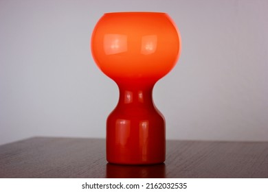 A 60s Modern Orange Bedside Lamp With Glass Spaceage Vintage Midcentury Design Front Side View Isolated On White Background With Warm Orange Light In The Studio Living Room Creative HQ 60s Furniture