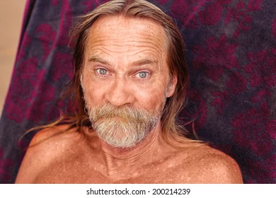 A 61 Year Old Man Sunbathing At The Swimming Pool -- Image Taken Outdoors Using Natural Light  (Reno, Nevada, USA)