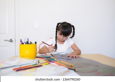 6-7 Years Old Girl Is Coloring And Drawing