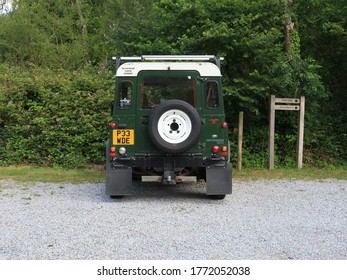 6th July 2020- A Classic Land Rover Defender 90 Parked In A Public Parking Area At A Woodland Garden Gear Amroth, Pembrokeshire, Wales, UK.