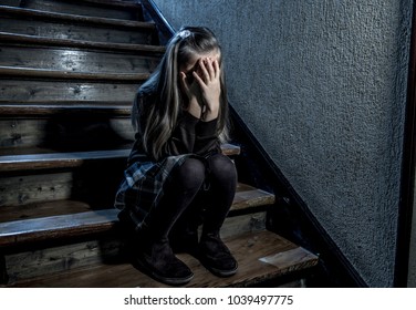 7 or 8 years old sad depressed and worried schoolgirl sitting on staircase desperate and scared suffering bullying and harassment at school in dramatic lighting and bullied children concept - Powered by Shutterstock