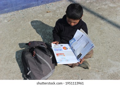 7 April 2021, Chamoli, Uttarakhand, India. A Little Indian Kid Studying Outside In His Village After Lockdown.