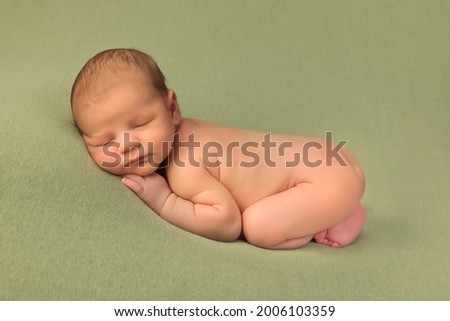 Similar – Baby yawning lying on a carpet