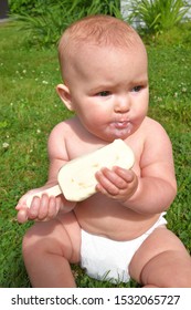 7 Month Old Baby Girl In A Diaper Eating A Frozen Yogurt Bar (Baby Led Weaning)