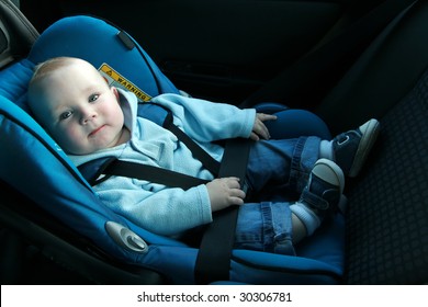 7 months old baby boy in a safety car seat. Safety and security