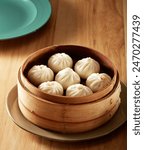 7 xiao long bao in a steamer basket