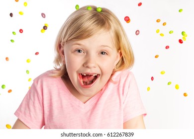 A 7 Year Old Blonde Child On White Background Raining Candy