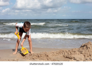 7 Years Old Boy Digging In The Sand - Kids