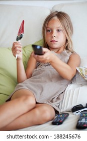 7 Years Old Child Watching Tv Sitting On Sofa At Home