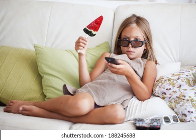 7 Years Old Child Watching Tv Sitting On Sofa At Home