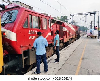 7th August, 2021 New Delhi Railway Station, India,  Train Engine Driver Talking To Track Engineer With Mask. A Passenger Train On New Delhi Railway Station (India) Waiting For Green Signal.