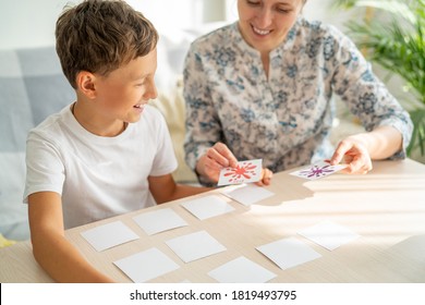 7-year-old Boy Plays A Memory Board Game With His Mother To Develop Memory And Attention At Home. The Child Plays With The Flash Cards, Fun To Spend Time With My Mother. Learning Colors And Language.