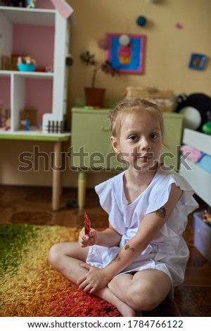 Similar – Funny child looking at the camera and painting