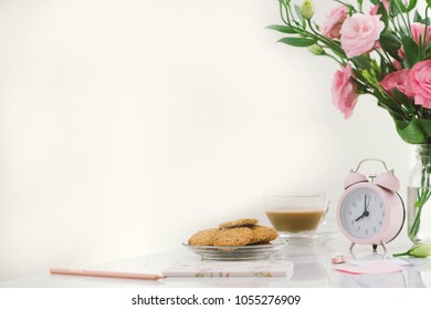 8 Am Clock. Cookies And Flowers On The Table.