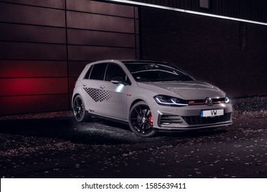 8 December 2019 Riga, Latvia Volkswagen VW Mk7 Golf GTI TCR (road car) Touring Car Racing standing on parking slot by modern house at night time. Led lights on.