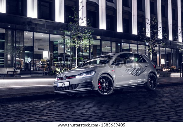 8 December 2019 Riga,\
Latvia Volkswagen VW Mk7 Golf GTI TCR (road car) Touring Car Racing\
standing on parking slot by modern brick house at night time. Led\
lights on.