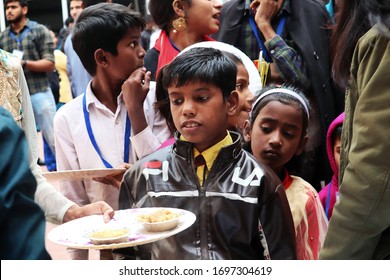 8 March 2020, New Delhi, India; Hungry Poor Children Are Being Feed By Social Workers In The Global Pandemic Of Corona Virus. Free Food For Homeless People, Distribution Of Humanitarian Food. 