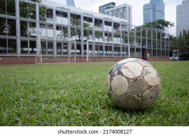 8 May 2022: Old Football On The Soccer Field, Heading To The Goal. Assumption Commercial College, Bangkok, Thailand