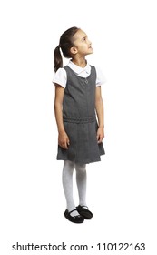 8 Year Old School Girl Looking Up Smiling On White Background