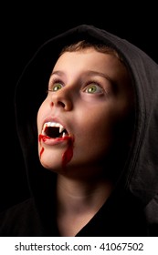 8 Years Old Boy Dressed As A Vampire With Fake Blood And Fangs