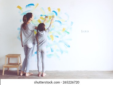 8 years old girl painting the wall at home  Instagram style toning