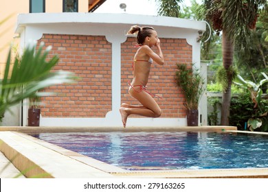 8 years old girl playing in swimming pool at hotel