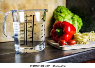 800ccm / 800ml Of Water In A Measuring Cup On A Kitchen Counter With Food