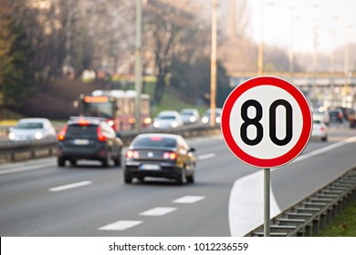 80km/h Speed limit sign with a traffic in the background on a highway full of cars - Shutterstock ID 1012236559