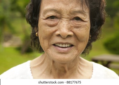 80's Asian Senior Woman At Park In A Morning