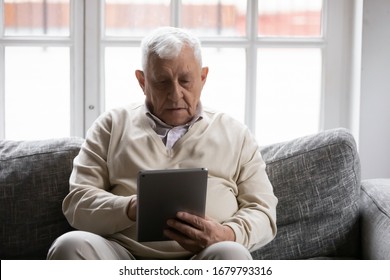 80s Mature Hoary Man Spend Time Seated On Couch At Home With Tablet Device, Makes Video Call To Therapist, Learn Helpful Application. Older Generation And Modern Technology Gadgets Easy Usage Concept