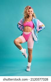 The 80s was quite a colourful era. Studio shot of a beautiful young woman wearing a 80s outfit.