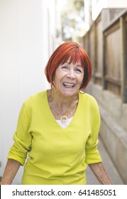 85 year old enjoying life with vibrant red hair - Shutterstock ID 641485051