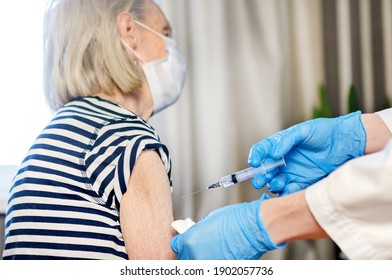 85-year-old woman receives the covid-19 vaccine from a doctor at home. Vaccination of the elderly. An elderly woman is vaccinated against COVID-19 in a nursing home.