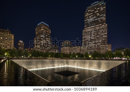 9 11 memorial shot at night with building in the back