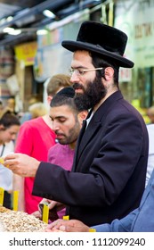 9 May 2018 An Orthodox Chassidic Jew Making A Purchase From A Stall In The Mahane Yehuda Street Market In Jerusalem Israel