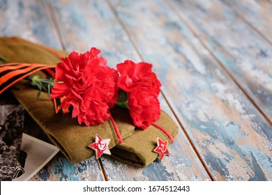 9 May holiday. Victory Day background - George ribbon, red flowers carnation. - Shutterstock ID 1674512443