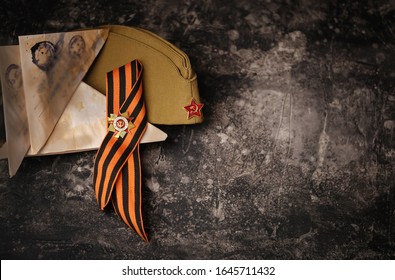 9 May, victory day holiday background. ribbon of St.George, soldier's war letter, old military cap  - traditional symbol of Victory Day 1945. 
