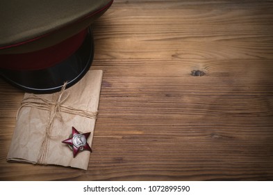 9 nine may Victory day concept background. The Great Patriotic War. Order (medal) of the red banner star, military cap and notes from the front.