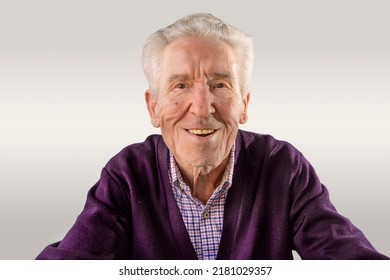 90 Year Old Man In Purple Sweater Looking At Camera Happy