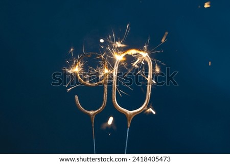 90 years celebration festive background made with Bengal fires in the form of number Ninety.
