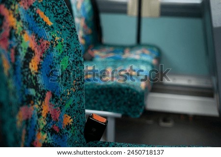 90s 80s style pattern plush velvety fabric of bus seats abstract bright colorful design with headrest buckle
belt 