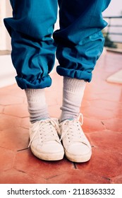 90s style white shoes and socks with rolled up loose pants