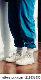 90s style white shoes and socks with rolled up loose pants