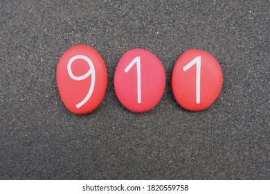 911, Emergency Telephone Number With Red Colored Stone Numbers Over Black Volcanic Sand