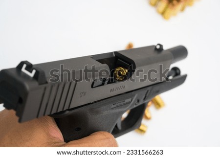 9mm automatic micro sompact pistol with bullet on white background home defence