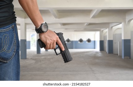 9mm Automatic Pistol Holding In Right Hand Of Shooter At The Shooting Range, Concept For Security, Robbery, Gangster, Bodyguard Training. Selective Focus On Pistol.