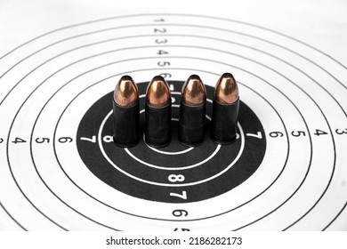 9mm Black Bullets On Circle Shooting Target Paper, Soft And Selective Focus On Bullet.