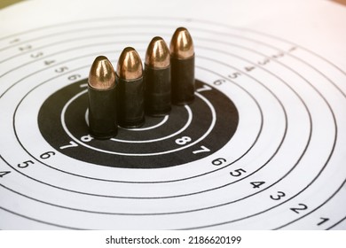 9mm Black Bullets On Circle Shooting Target Paper, Soft And Selective Focus On Bullet.