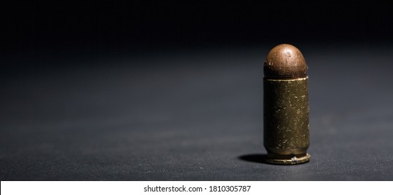 9mm bullet for pistol and self-defense on black background